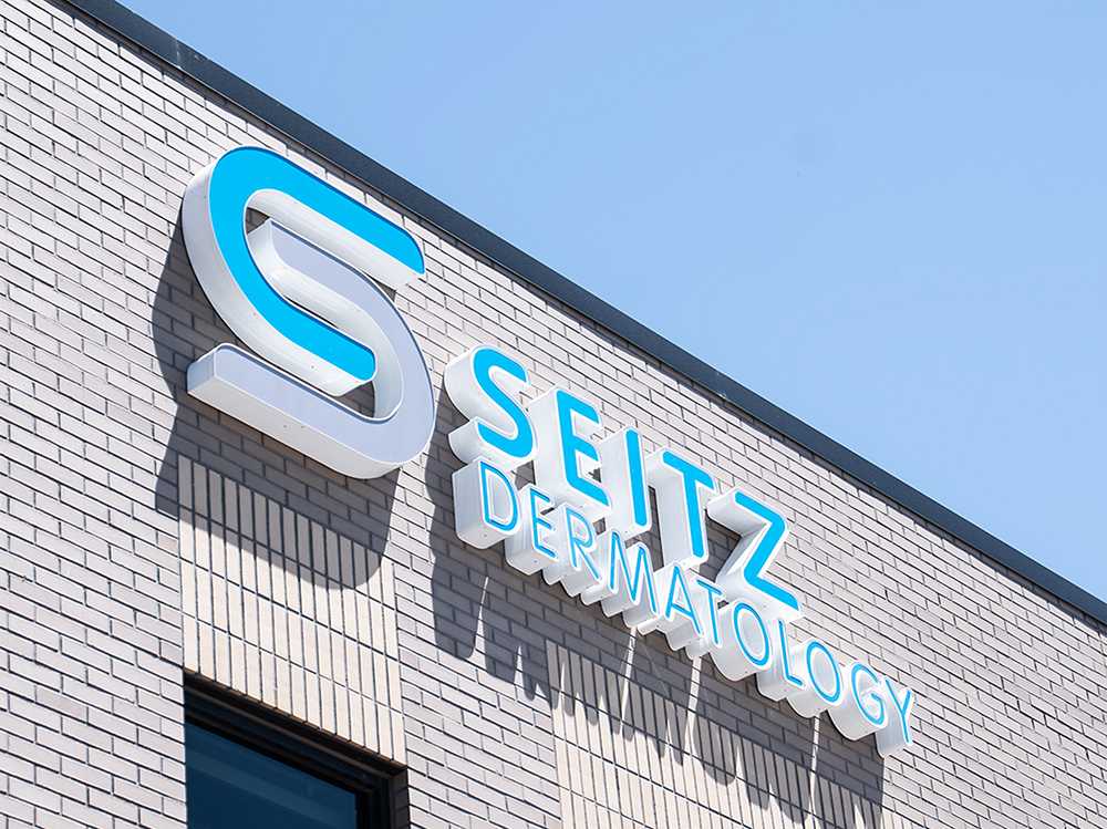 A sign that says "Seitz Dermatology" on a building